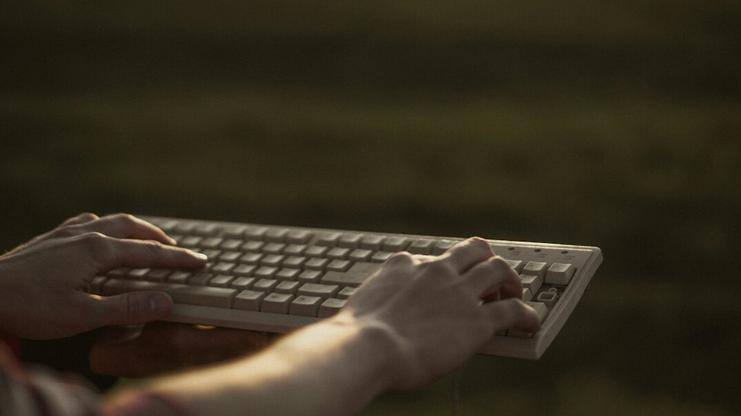 hands typing code on keyboard