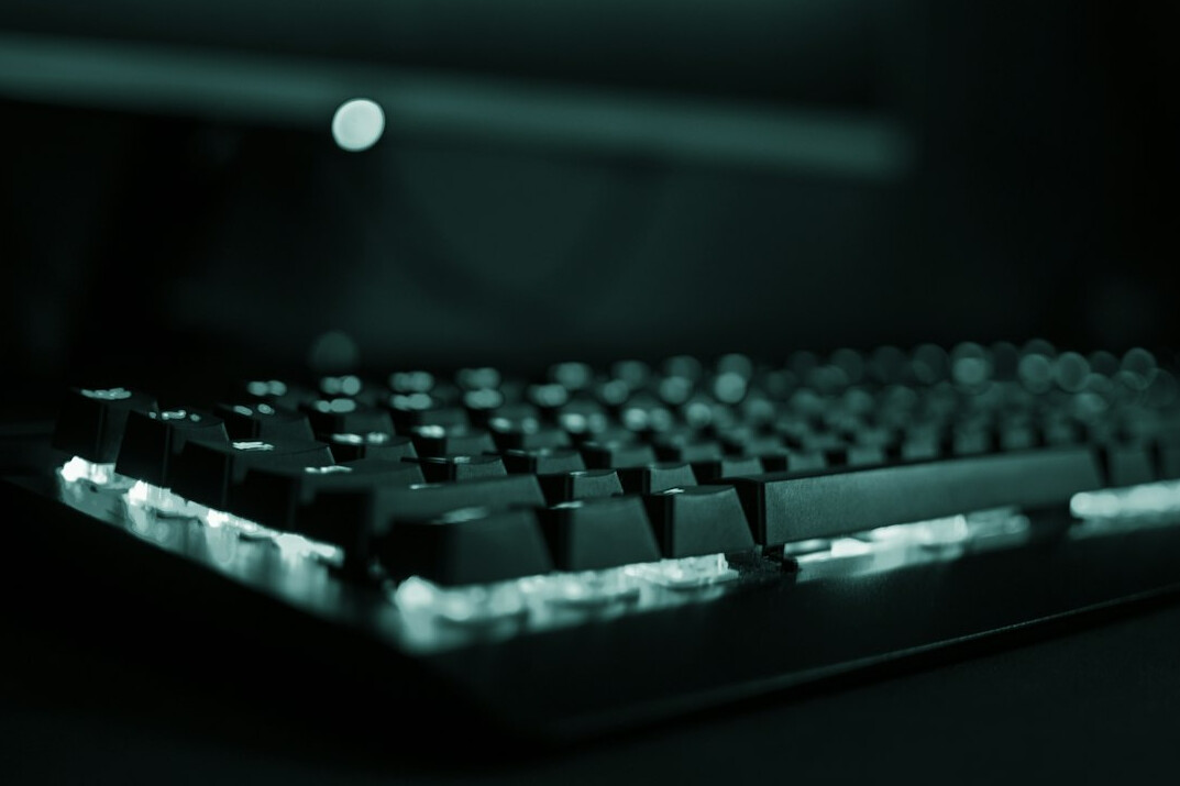 Close-up of hands typing on a mechanical keyboard