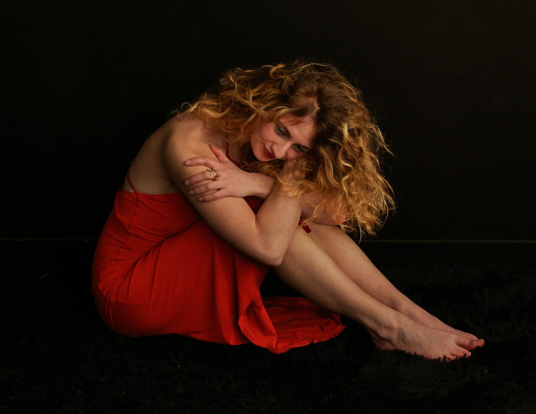 Studio portrait of a woman with curly hair