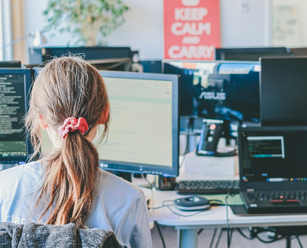 successful coder at desk