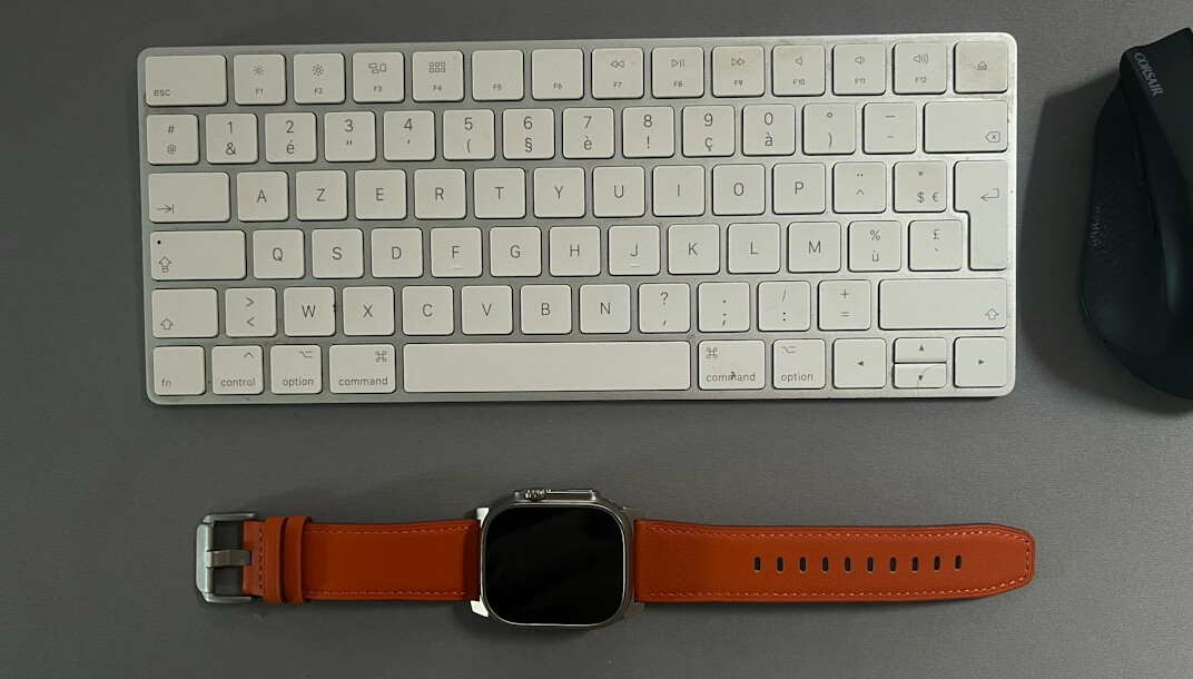 Flat-lay of a desk workspace with notebook and laptop