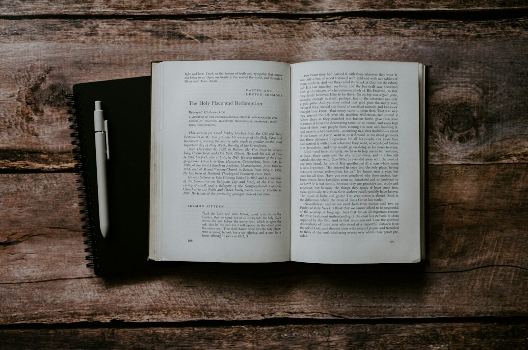 Open notebook with handwritten pseudocode and a pen