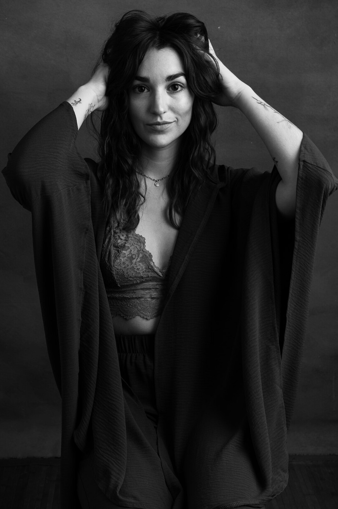 Studio portrait of a smiling woman with dark hair